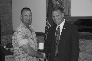 Col. Joseph Granata, USMC (l), commanding officer, Combat Logistics Regiment, 1st Marine Logistics Group, accepts a token of appreciation from Maj. Mark Witzel, USMC (Ret.), chapter president, for speaking at the May meeting. 